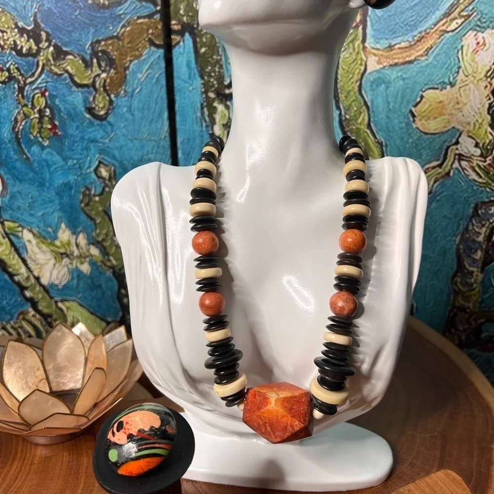 Three piece, rust and black stone and beaded costume jewelry.